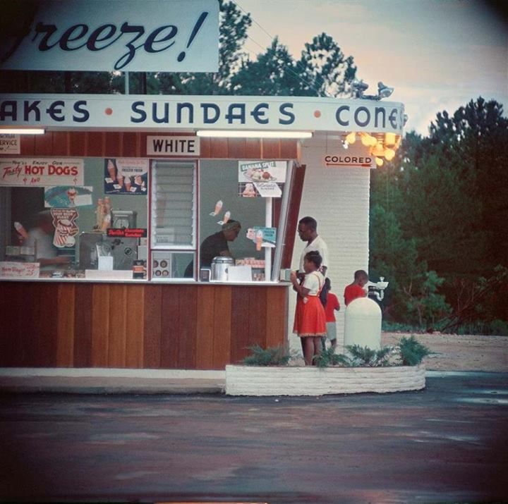A black family buying food at a segregated ice cream stand, by Gordon ...